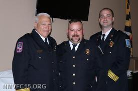 Quartermaster Chris Miles receives a top responder award from Chief Ben Nalborczyk and Deputy Chief Bucky Kennedy